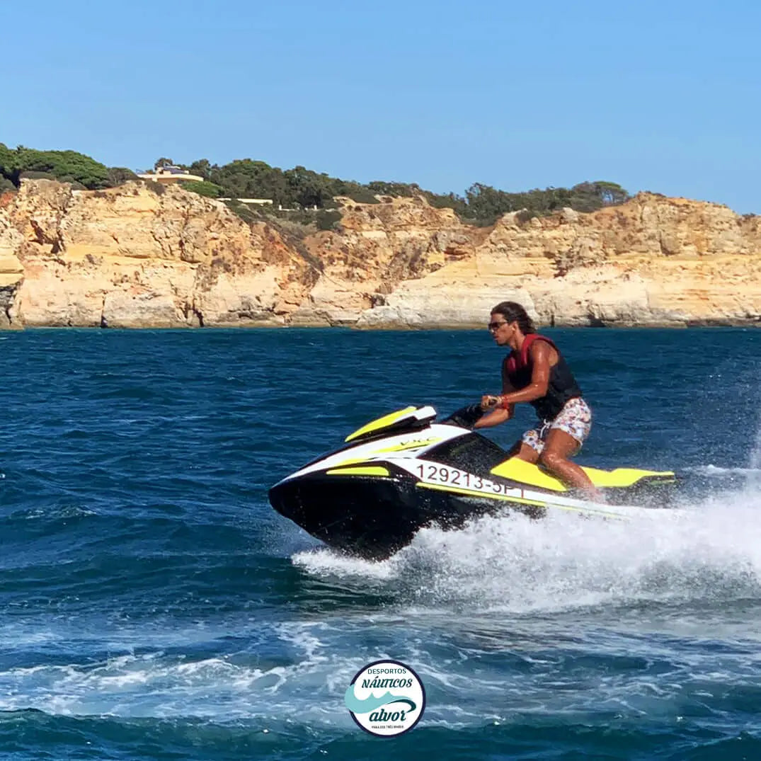 Person on a jetski on the clear waters of Alvor, showcasing thrilling water fun.