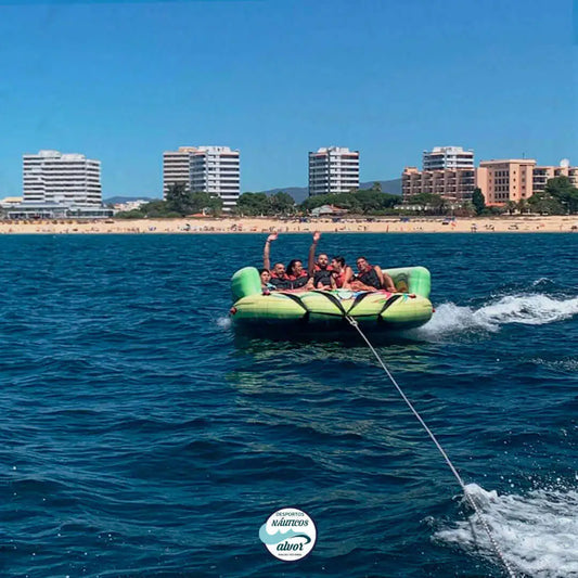 group of people enjoying the Inflatable Sofa ride on the clear waters of Alvor, showcasing thrilling water fun.
